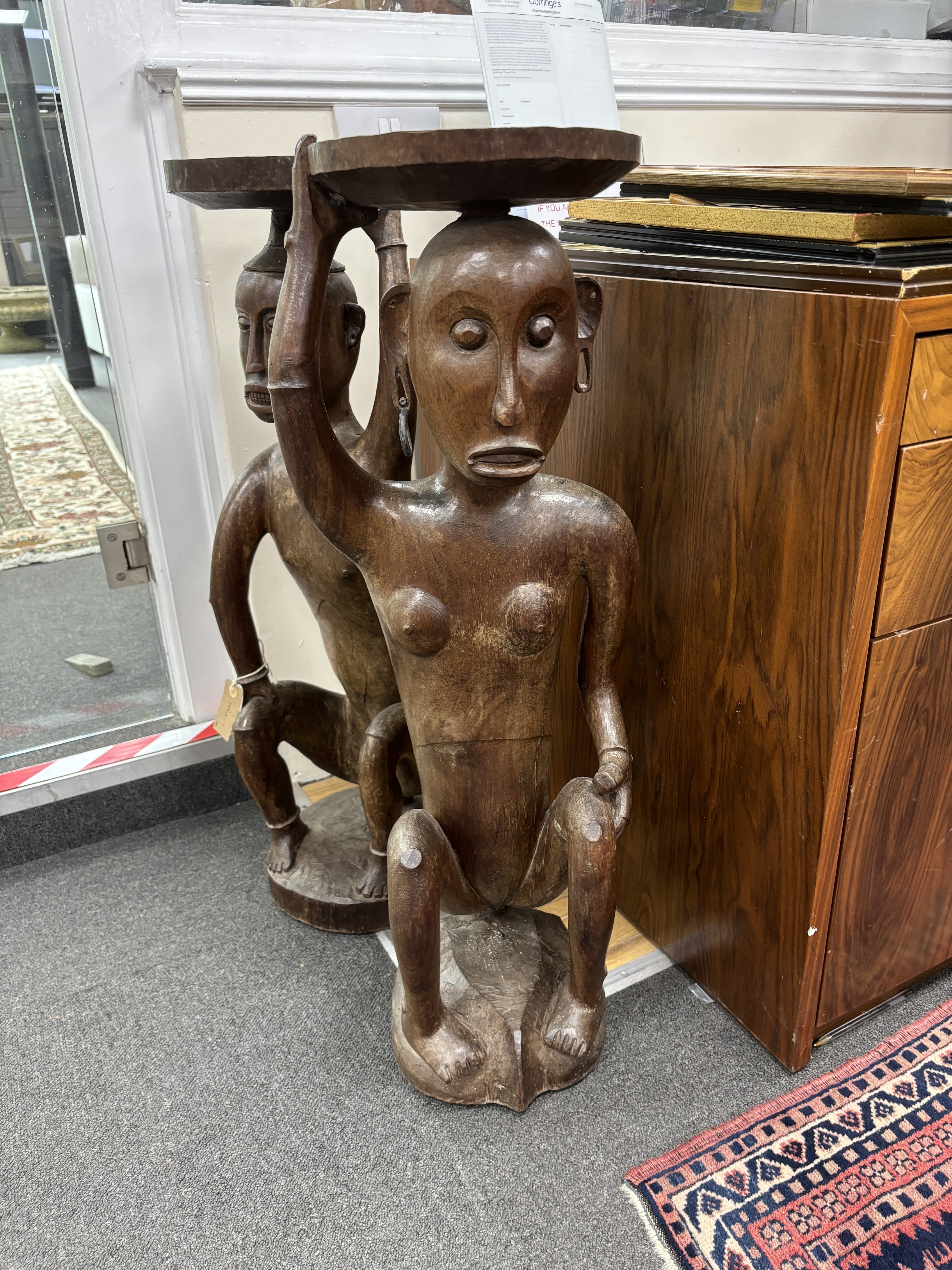 A pair of Sarawak carved hardwood figures. height 85cm